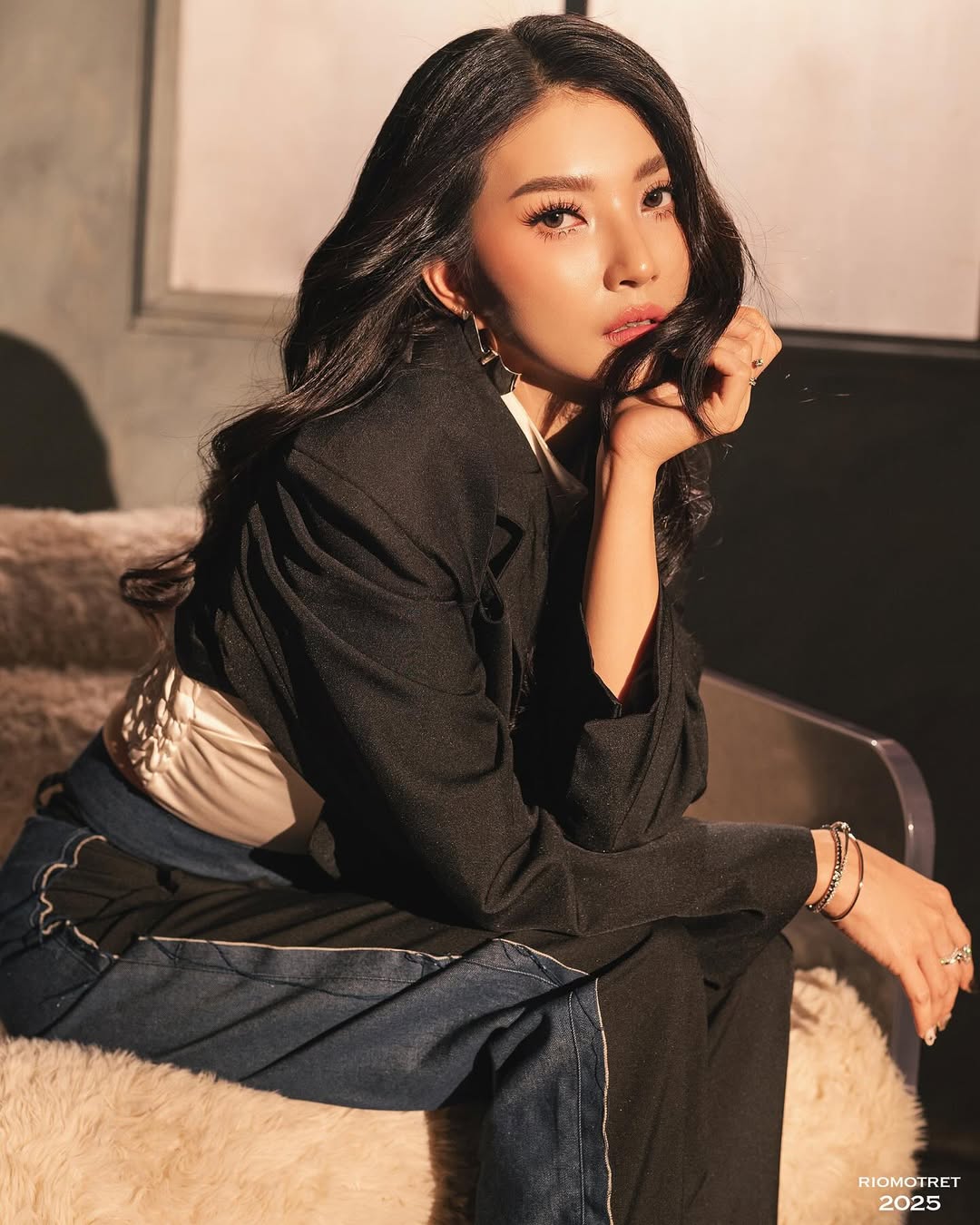 Komta campaign portrait seated on lounge chair